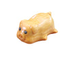 Close-up view of a small light brown carved wooden pig figurine
