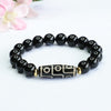 Black agate beaded bracelet with a central nine-eye Dzi bead and gold-tone accents