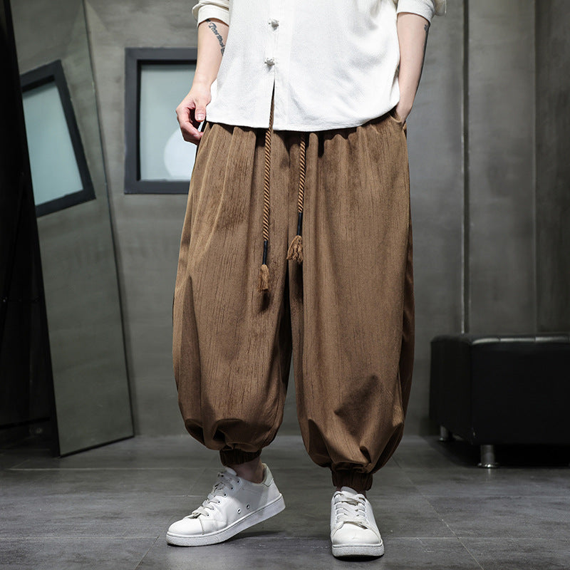 Model wearing brown corduroy harem pants with white sneakers