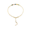 Close up of a thin yellow citrine beaded bracelet with gold clasp on white background