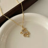 Gold-tone dragon pendant necklace worn by a woman