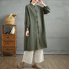 Model wearing a green cotton linen women's coat with frog buttons