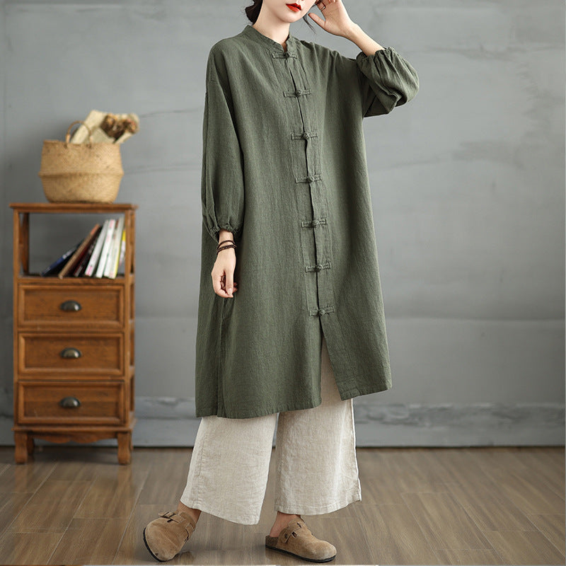 Model wearing a green cotton linen women's coat with frog buttons