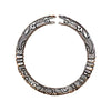 Close up of a silver dragon head carved open bangle held in hand