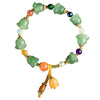 Close up of a green stone bracelet with carved magnolia flowers and colorful spacer beads on a soft background