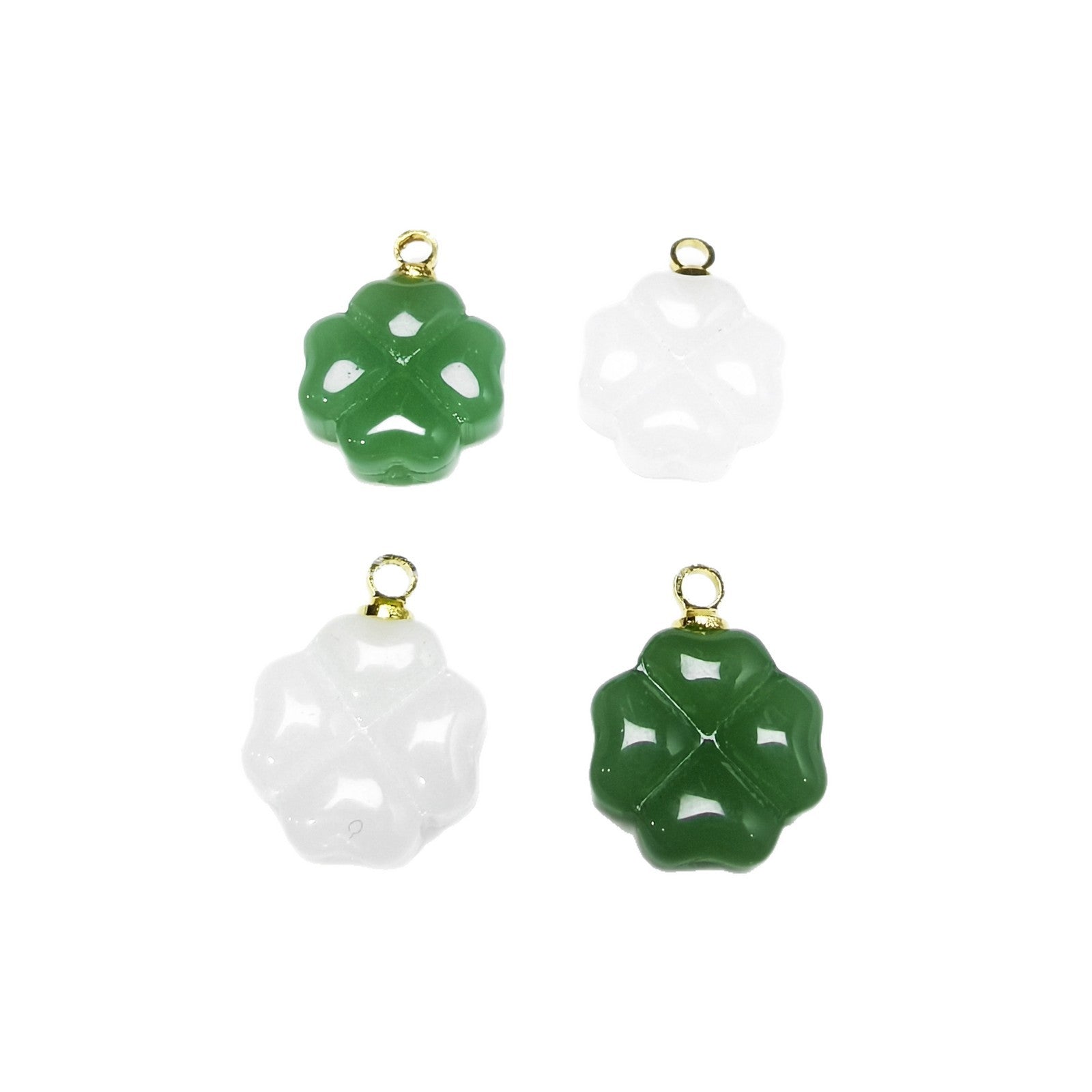 Two green and two white glass clover pendants with gold loops on a white background