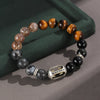 Close up of beaded bracelet with tiger eye and silver Wukong charm