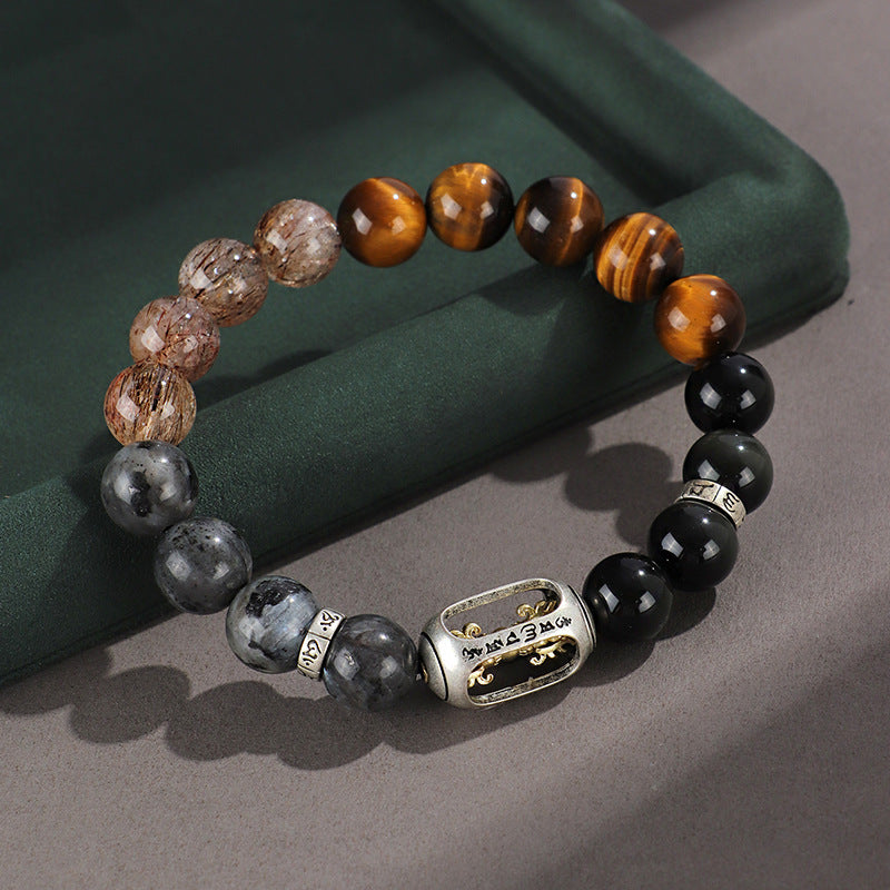 Close up of beaded bracelet with tiger eye and silver Wukong charm