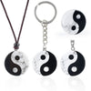 Round Yin Yang pendant with black and white stone pattern on a cord