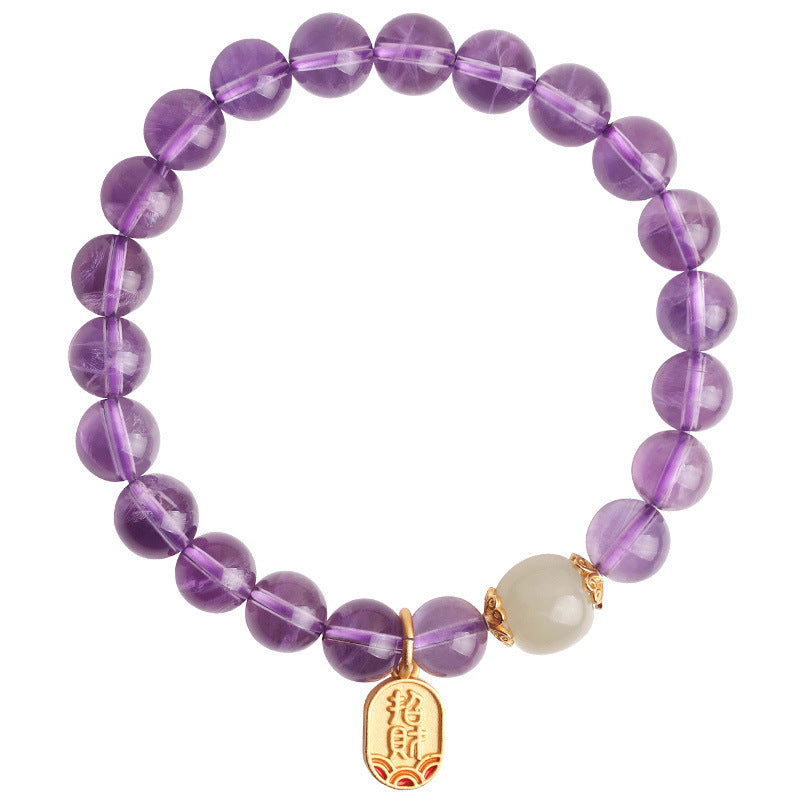 Purple beaded bracelet with white jade and gold charm on wrist