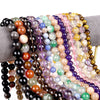 Multiple strands of colorful polished natural stone beads on a display stand