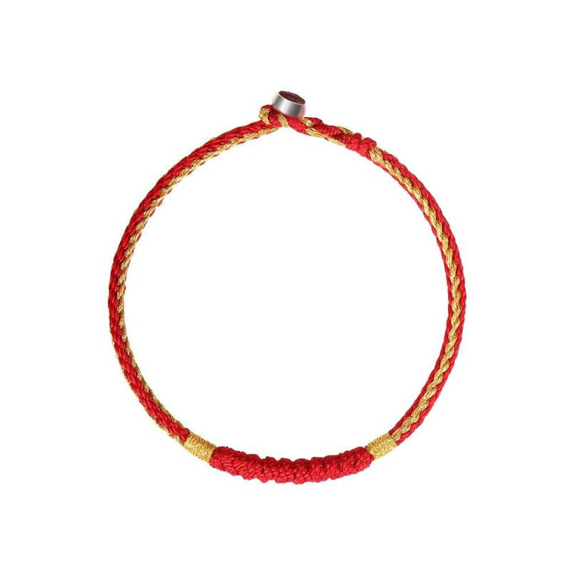 Close up view of a red and gold tone handmade braided bracelet