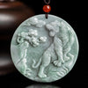 Round light green jade pendant carved with a roaring tiger and pine tree