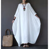 Woman wearing a white cotton linen long sleeve maxi dress