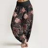 Woman wearing black harem pants with pink floral print and folded elastic waist