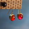 Red Stone Drop Earrings with Swastika Motif
