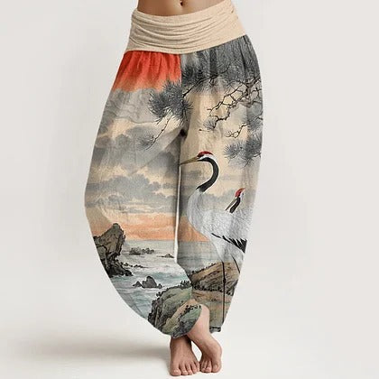 Model wearing light-colored cotton harem pants with a crane and landscape print