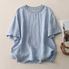 Light blue cotton linen short sleeve t-shirt with round neck laid flat