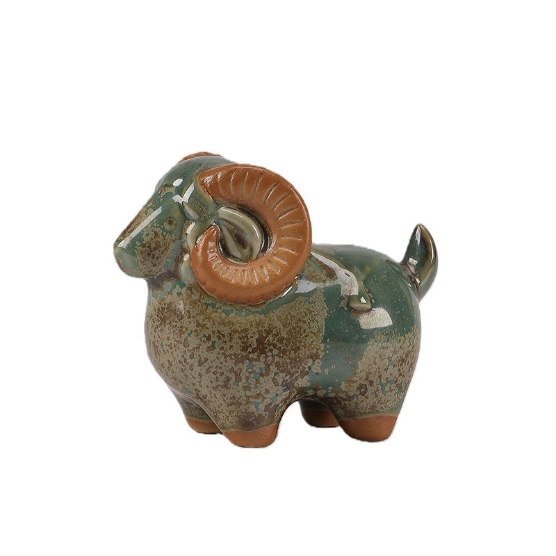 Close-up of a speckled green ceramic ram figurine on a white background