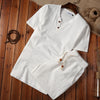 White cotton linen men's meditation cloth set with short sleeve top and shorts on wood floor