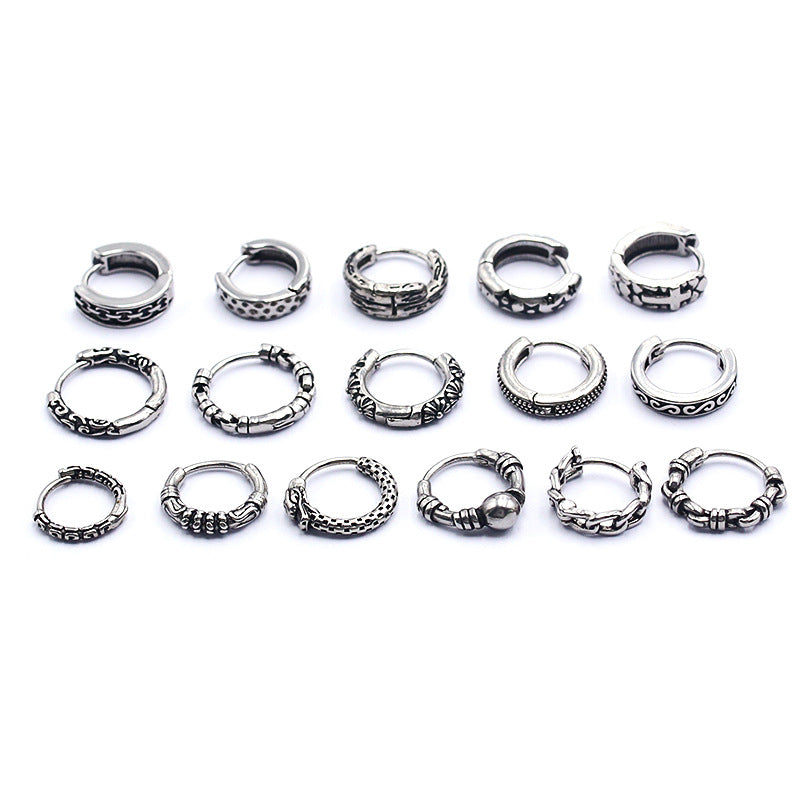 Collection of small silver-tone stainless steel hoop earrings with various textures on a white background