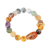 A beaded bracelet with mixed color natural crystals and a central rough stone on a white background