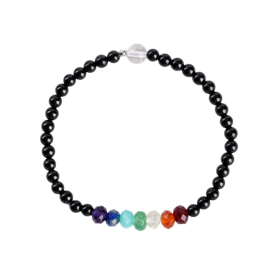 Close-up view of a black tourmaline bracelet with a row of rainbow colored stones on a light background
