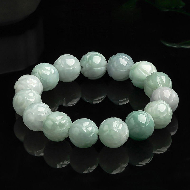 A strand of pale green jade beads carved into lotus flowers