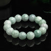 A strand of pale green jade beads carved into lotus flowers