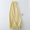 Yellow cotton linen harem pants with ruffled hem laid flat on white background