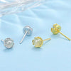 Close up of small heart shaped jade stud earrings in gold and silver tones