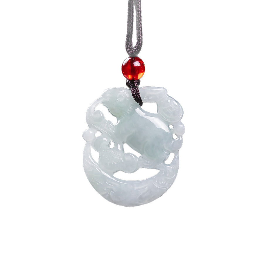 Close up of white jade rabbit pendant carved in openwork style on a dark cord