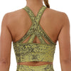 Back view of a woman wearing a green seamless yoga set with cross-back straps