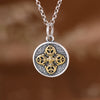 Round sterling silver pendant with gold-tone double dorje on chain