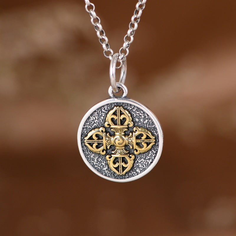 Round sterling silver pendant with gold-tone double dorje on chain