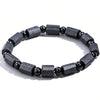 Close up of a black tourmaline bracelet with rectangular stones on a white background