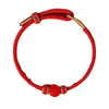Red woven bracelet with gold accents and a red zodiac charm on a white background