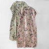 Two long sleeveless dresses with vintage paisley floral patterns and mandarin collars displayed flat.