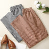 Folded black and red plaid cotton linen pants with elastic waistbands