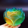 Hand holding a gradient green and yellow lotus glass incense burner