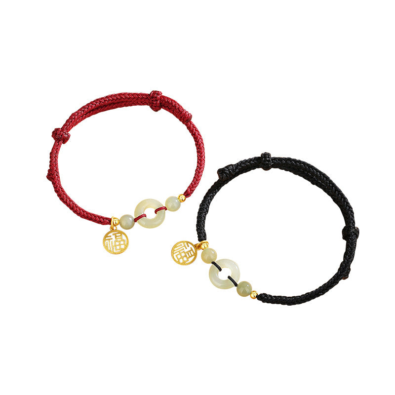 Two cord bracelets with jade peace buckles and gold charms on a white background