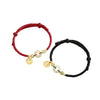 Two cord bracelets with jade peace buckles and gold charms on a white background