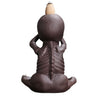 Back view of a brown skeleton-shaped backflow incense burner