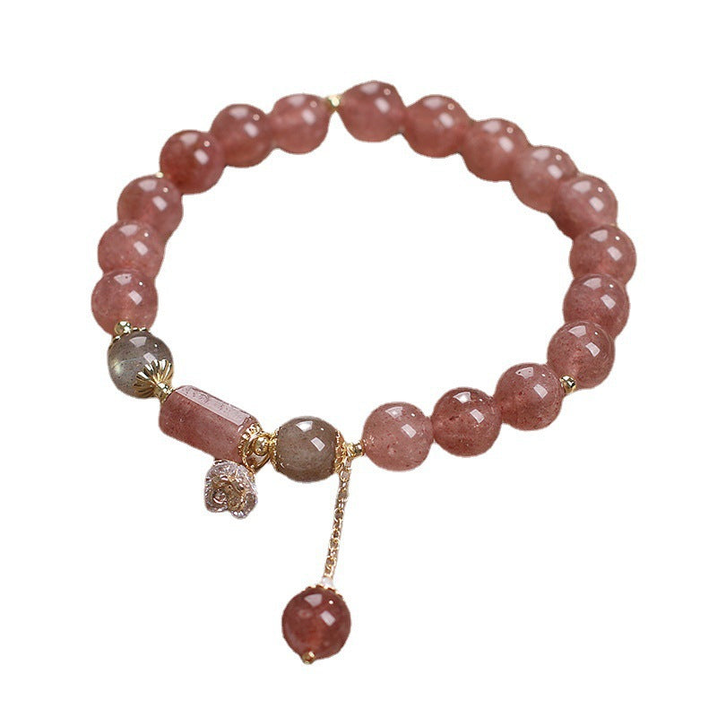 Pinkish-red beaded bracelet with gold-tone accents and a flower charm