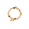 Close-up of a beaded bracelet with yellow citrine, brown tiger eye, and a carved pixiu charm.
