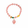 Pink strawberry quartz beaded bracelet with a carved fox pendant and gold-tone accents
