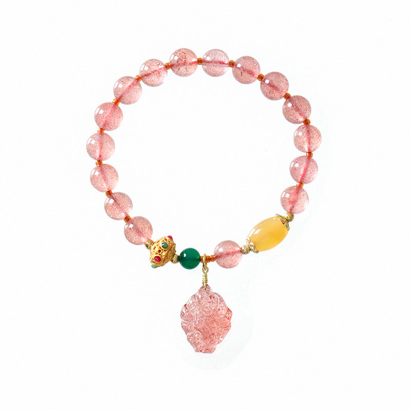 Pink strawberry quartz beaded bracelet with a carved fox pendant and gold-tone accents