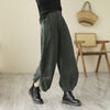 Model wearing black wide-leg corduroy pants with buttons on the side