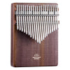 A wooden kalimba thumb piano with silver metal tines and a Tree of Life carving.