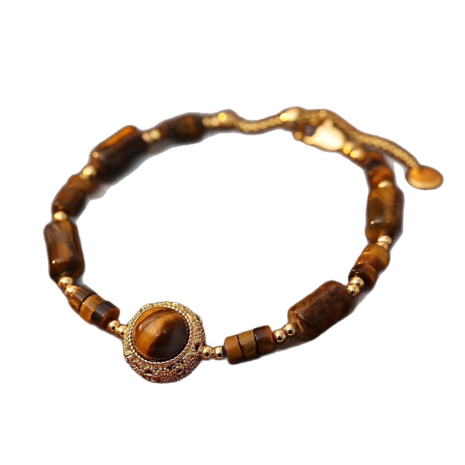 Close-up of a tiger eye bead bracelet with a gold-tone copper charm on a brown surface